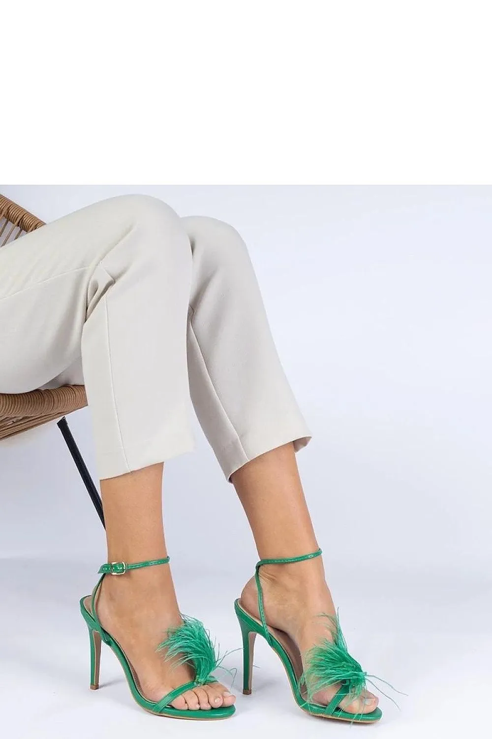 Green stiletto sandals adorned with feathers