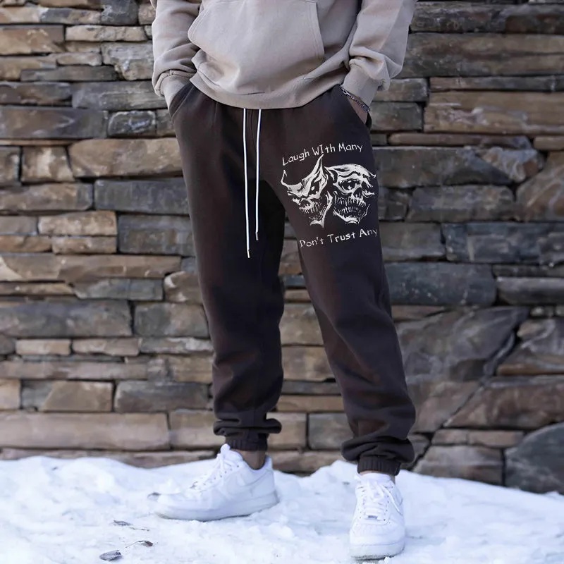 LAUGH WITH MANY, DON’T TRUST ANY SKULLS GRAPHIC PRINT JOGGERS
